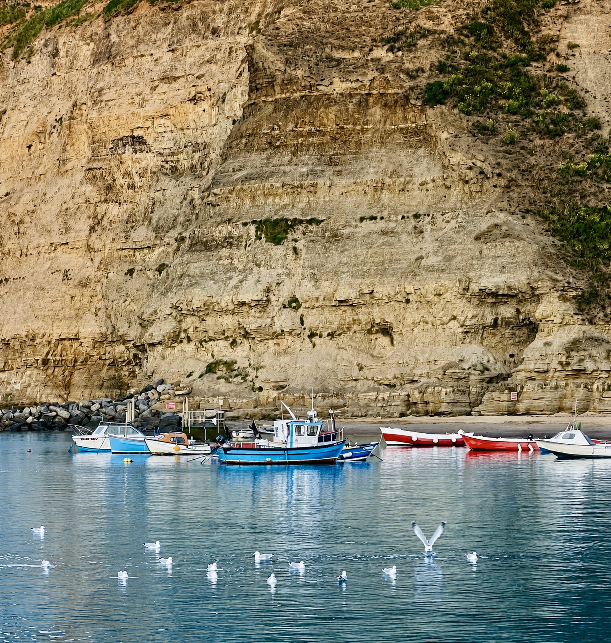 Fishing boats beneath the cliffs at Staithes