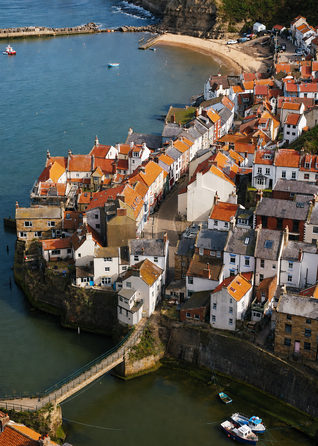 The red roofs, bridge and harbour of Staithes seen from above